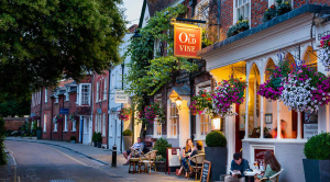 People enjoying an evening outside of a pub called The Old Vine